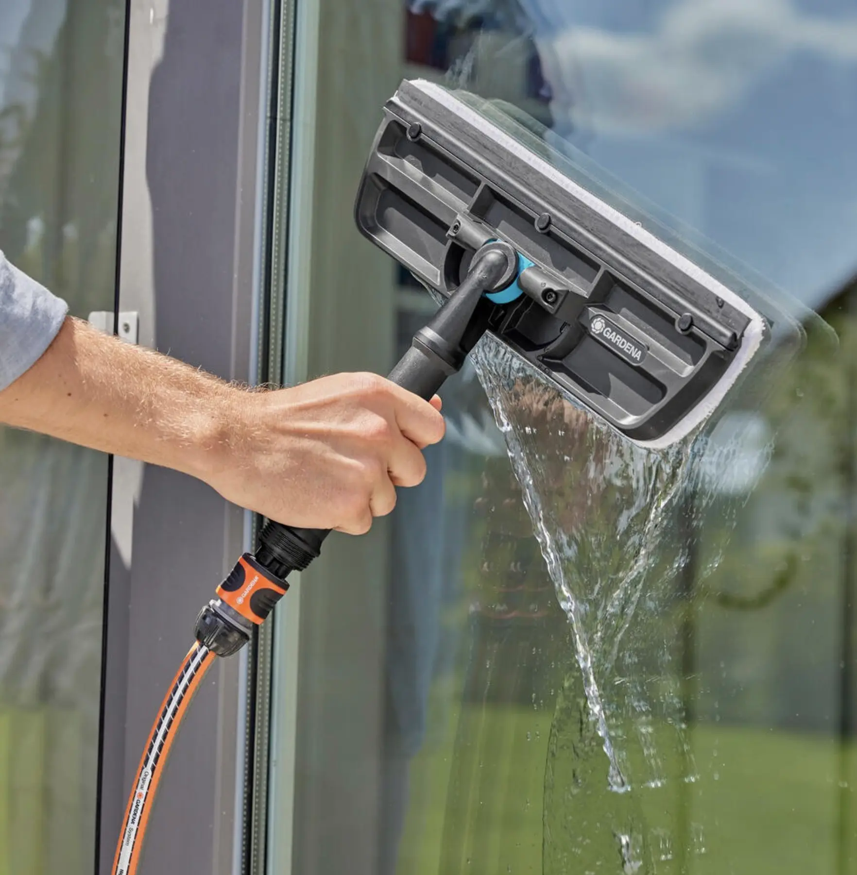 Professional using squeegee on commercial glass window
