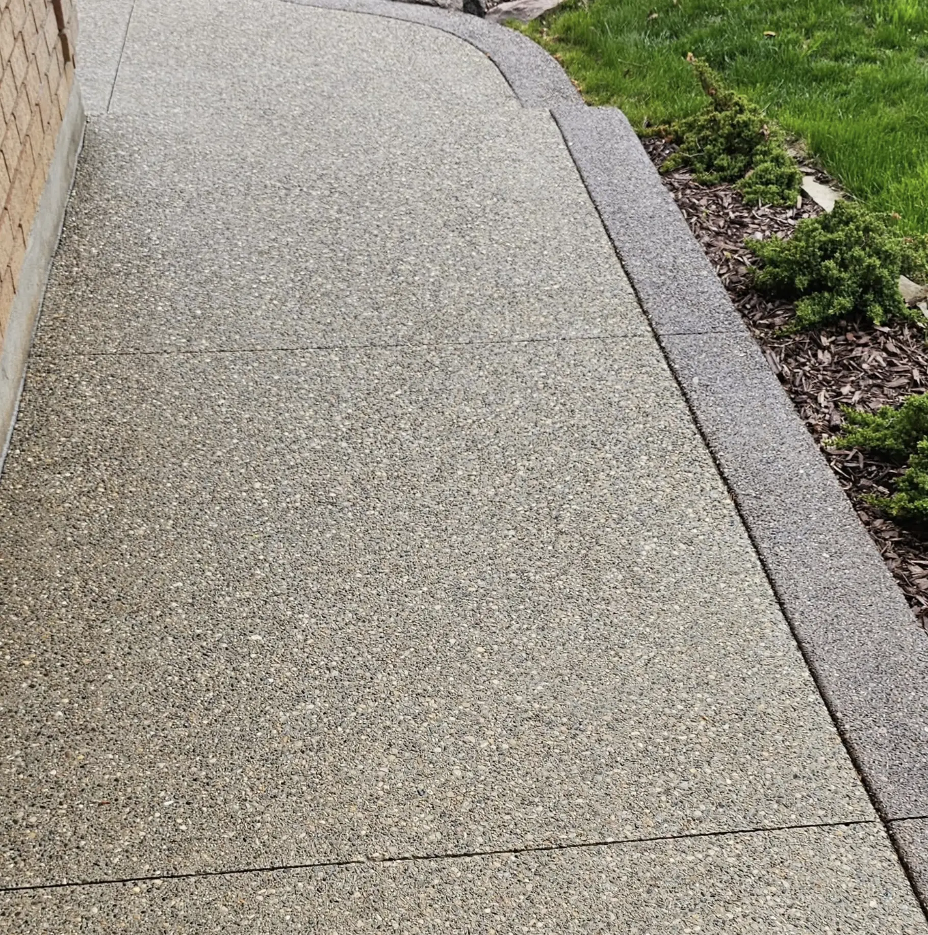 Sealed concrete driveway with glossy finish