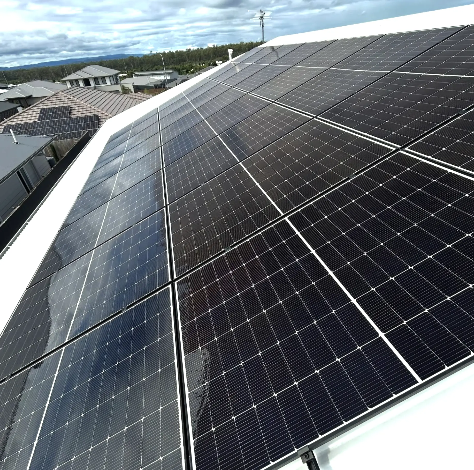 Technician cleaning rooftop solar panels