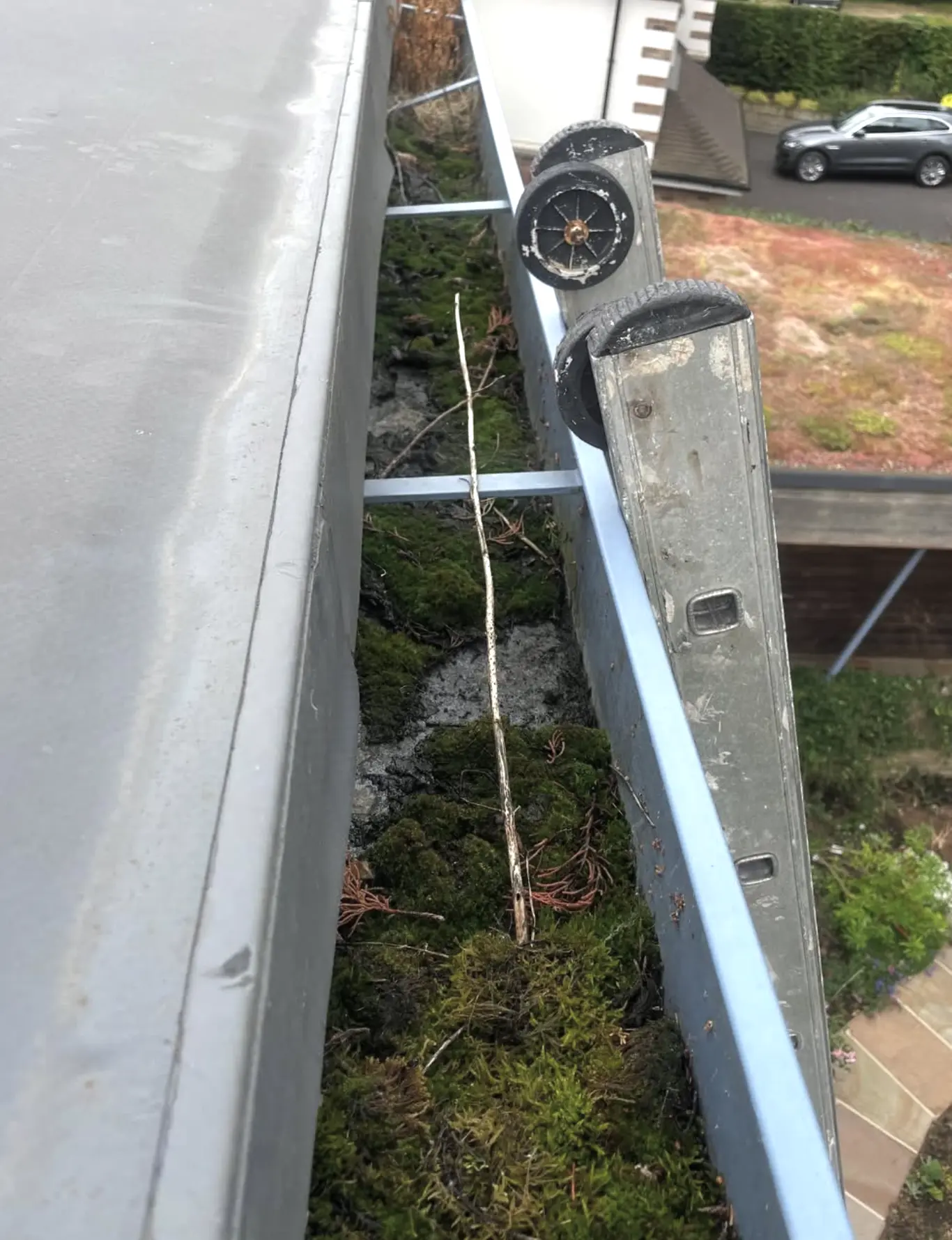 Worker clearing downpipe junction box